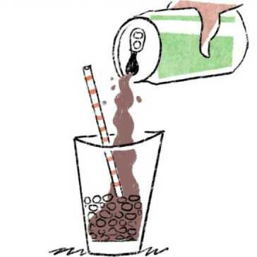 Someone pouring a can of soda into a glass.