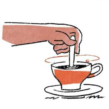 Someone stirring a cup of coffee.
