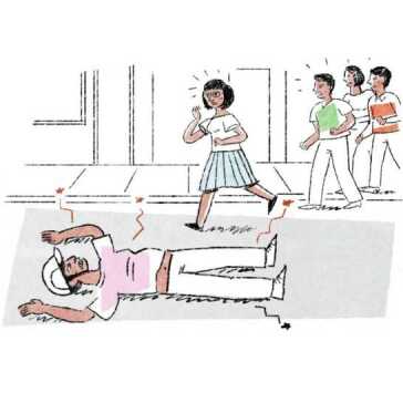 A man lying on the road and people rushing towards him.