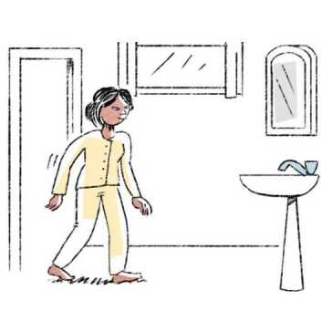 A woman walking into the bathroom.