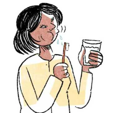 A woman rinsing her mouth.