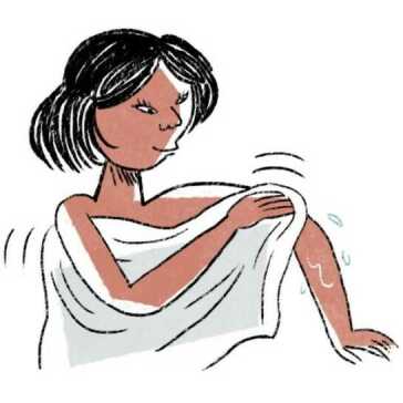 A woman drying herself with a towel.