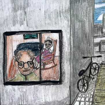 A man looking outside through a window and a woman sitting behind him.