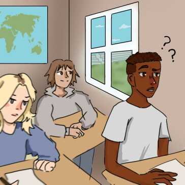 A boy sitting in a classroom looking confused.