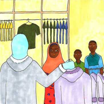 A man, woman and boy shopping for clothes.